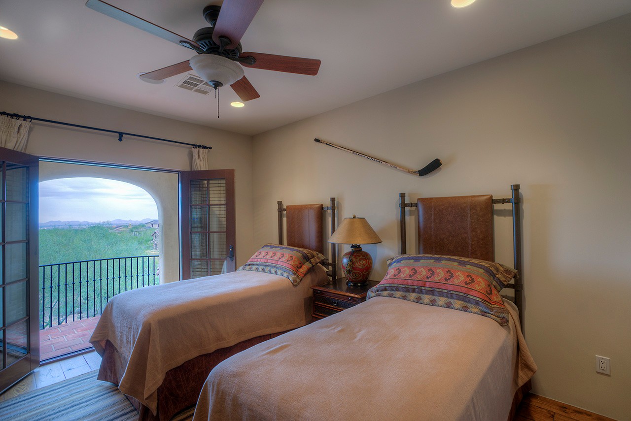 Guest bedroom with outdoor balcony at this Scottsdale home for sale located at 9290 E Thompson Peak Pkwy #455 Scottsdale, AZ 85255 listed by Don Matheson at The Matheson Team